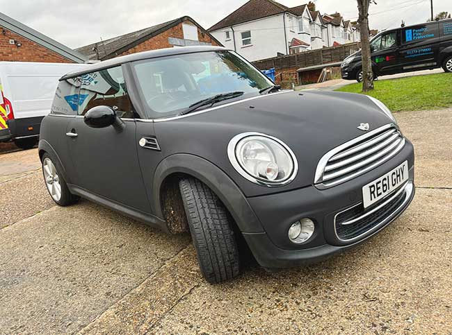modern mini make of car with matt black full vinyl wrap