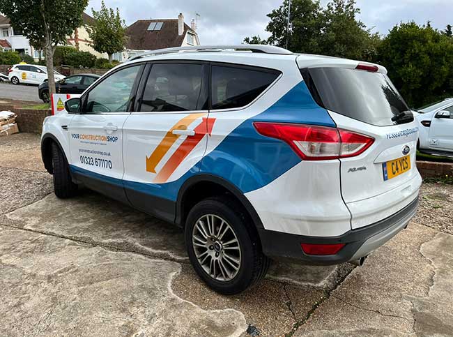 5 door medium sized family hatchback with vinyl signwriting promoting Your Construction Shop