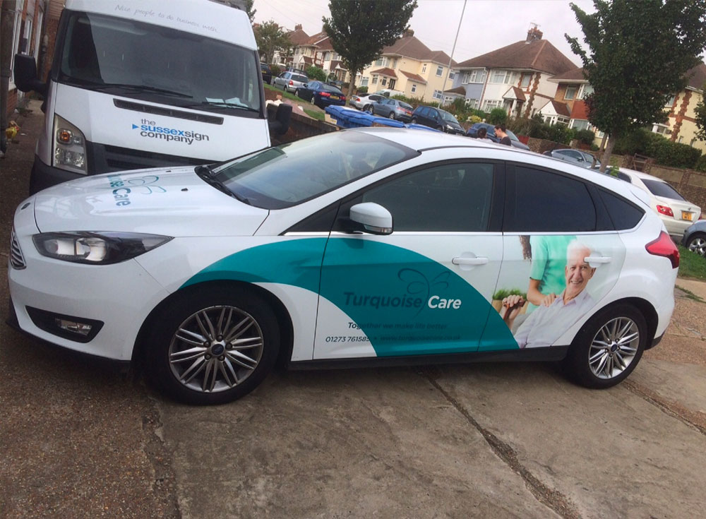Ford Focus with digitally printed vinyl signwriting promoting turquoise care in-home care services in East & West Sussex