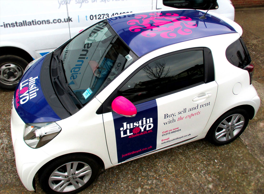 Toyota iQ 2 door car with digitally printed vinyl signwriting promoting Juston Lloyd estate agents of Brighton