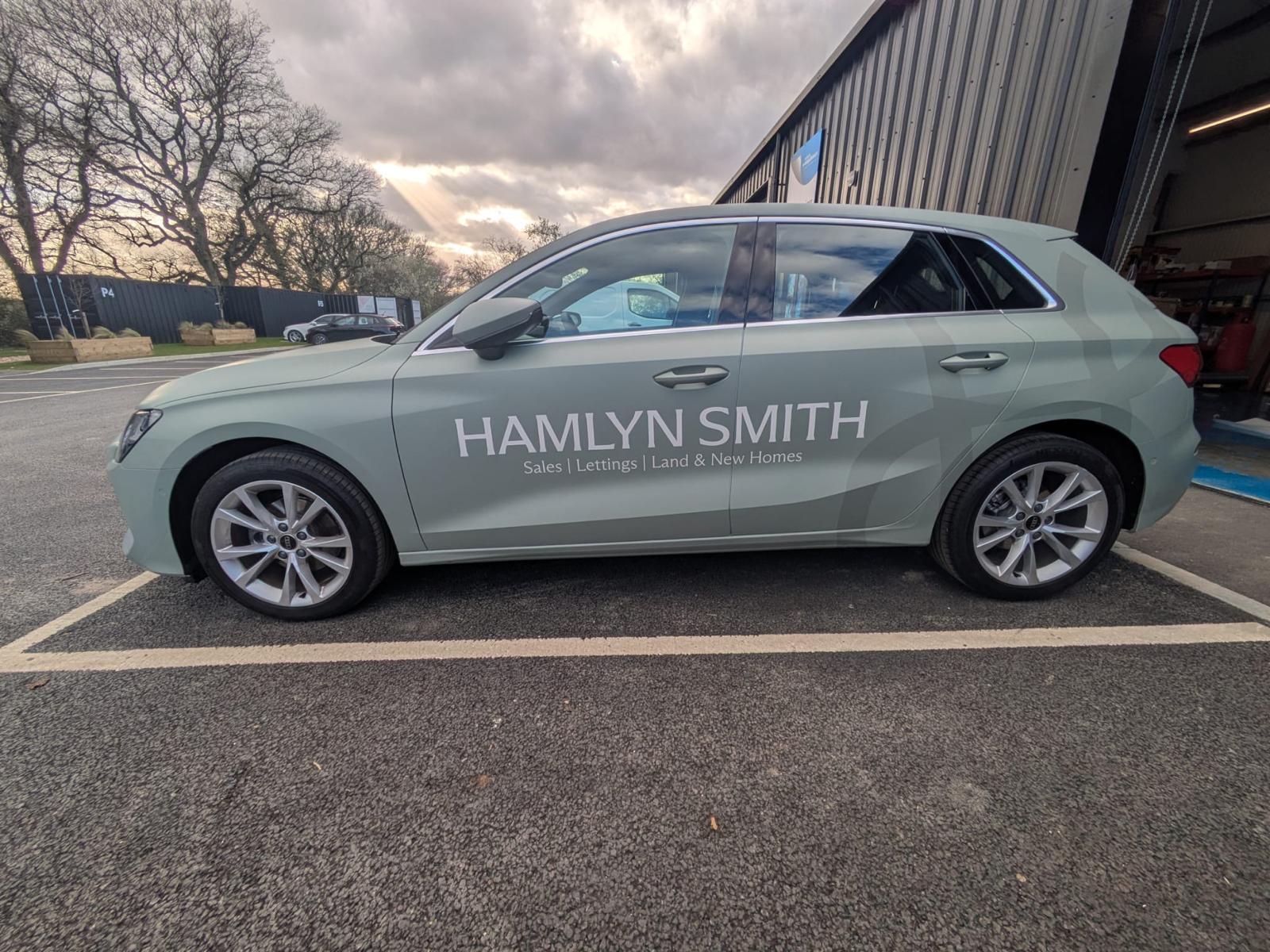 White Audi A3 transformed with a full colour printed sage green vinyl car wrap for Hamlyn Smith estate agents specialising in sales, lettings, land and new homes