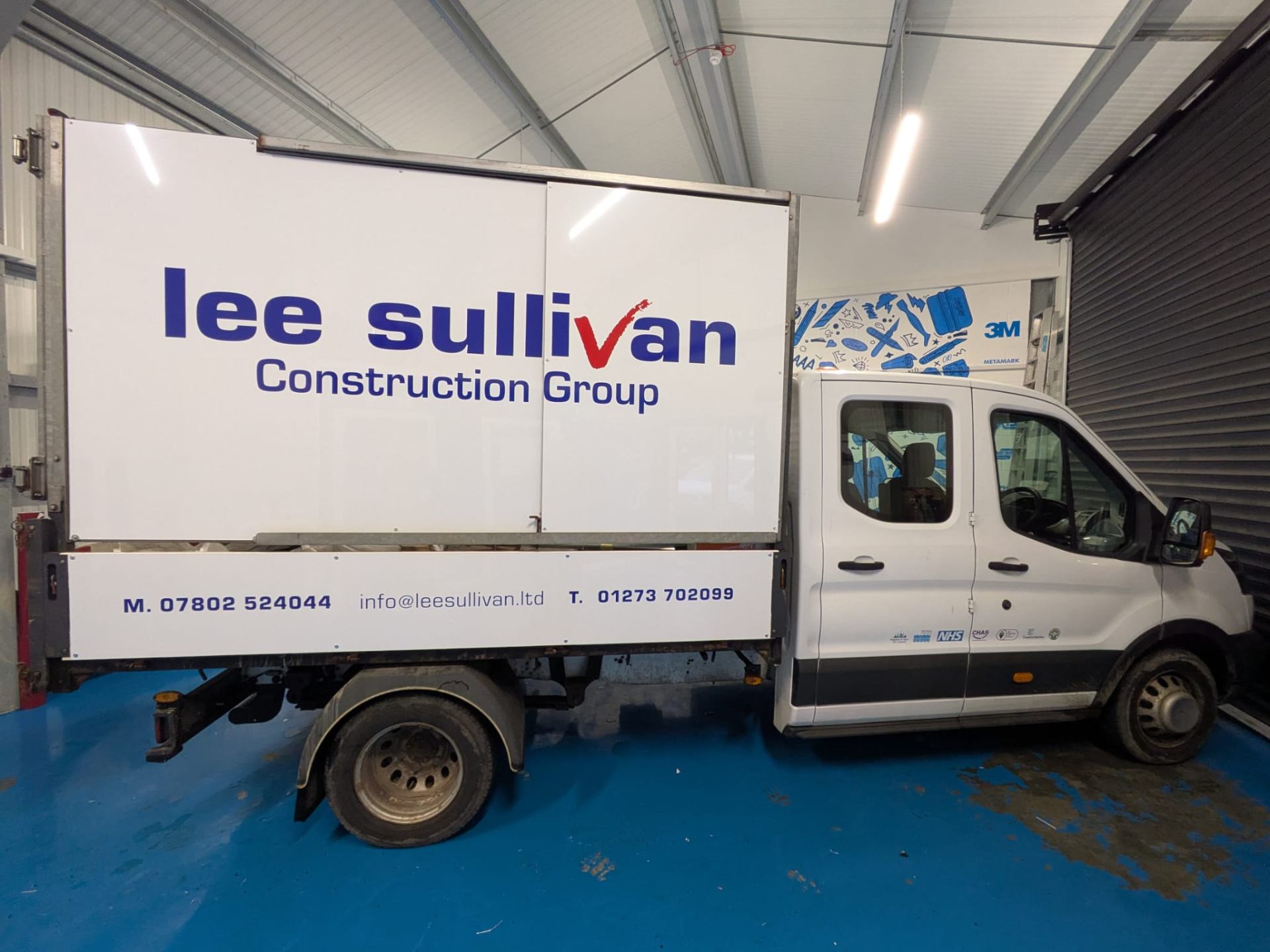 simple cut vinyl signwriting in 2 colours, red & blue, to a luton van advertising Lee Sullivan