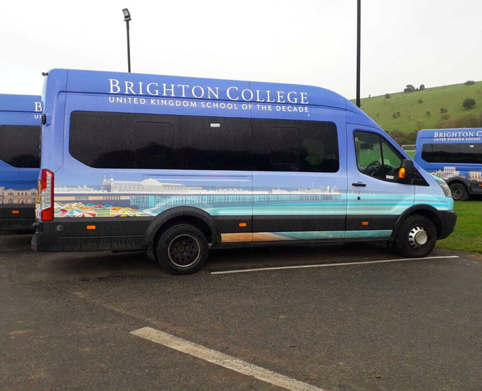 Brighton College minibus with school logo in white letters with Brighton Pier scene from a vinyl van wrap