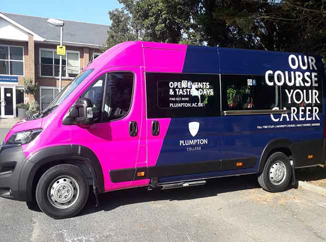 Plumpton College blue minibus with white vinyl lettering and a pink vinyl wrap to the front quarter