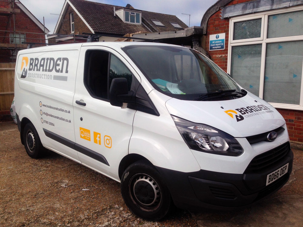 White Ford Transit van with printed and cut vinyl letters advertising Braiden Construction