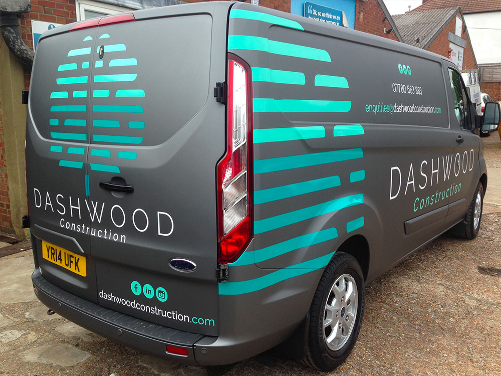 Two different colours of cut vinyl used to promote Dashwood construction services on a Ford Transit van rear quarter view