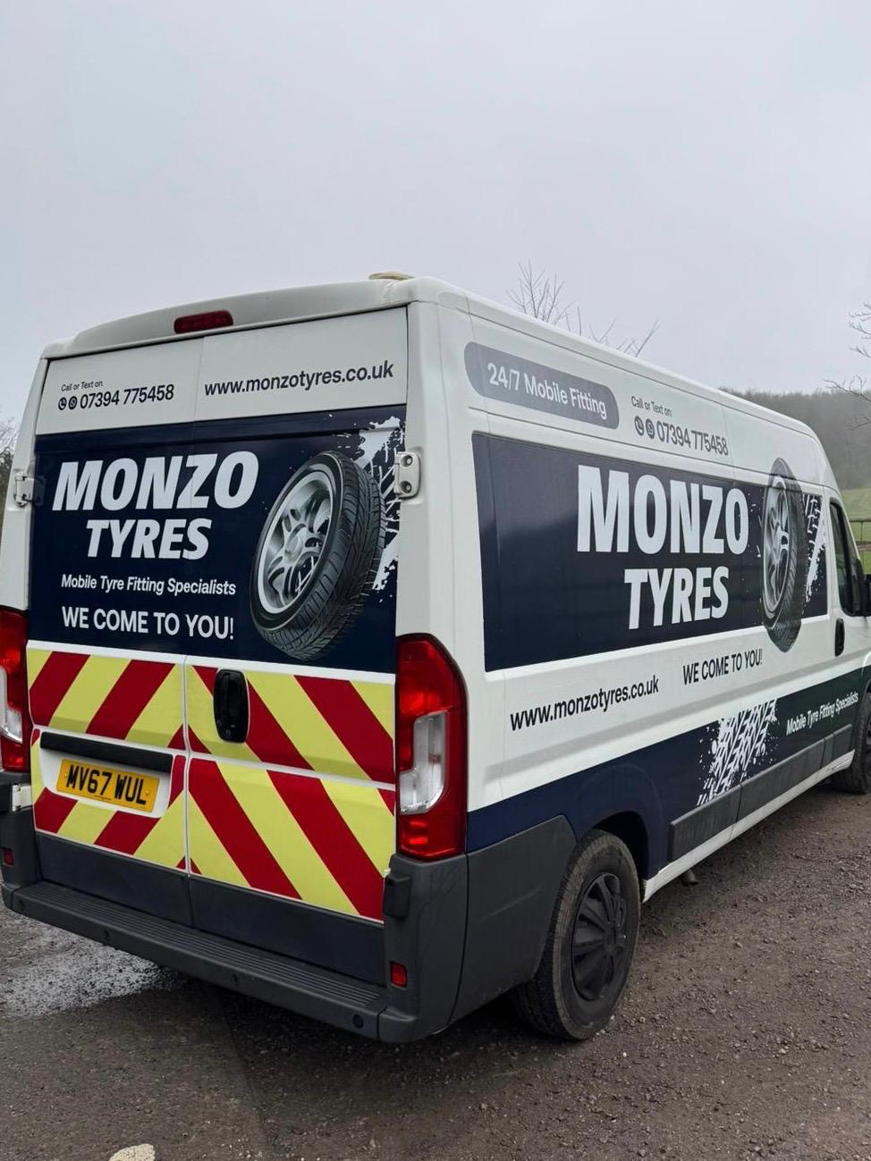 White Peugeot Boxer van with single-colour cut vinyl signwriting and a full-colour printed tyre design for Monzo Tyres mobile tyre fitting specialists