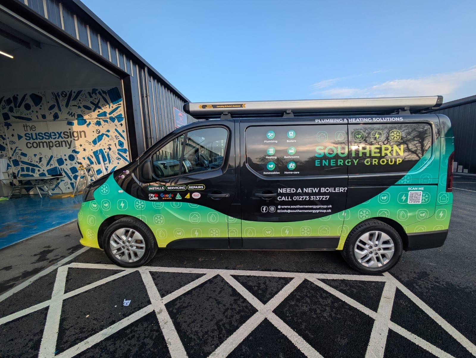 Black van with a partial printed vinyl wrap featuring a green and yellow gradient design for Southern Energy Group plumbing and heating solutions