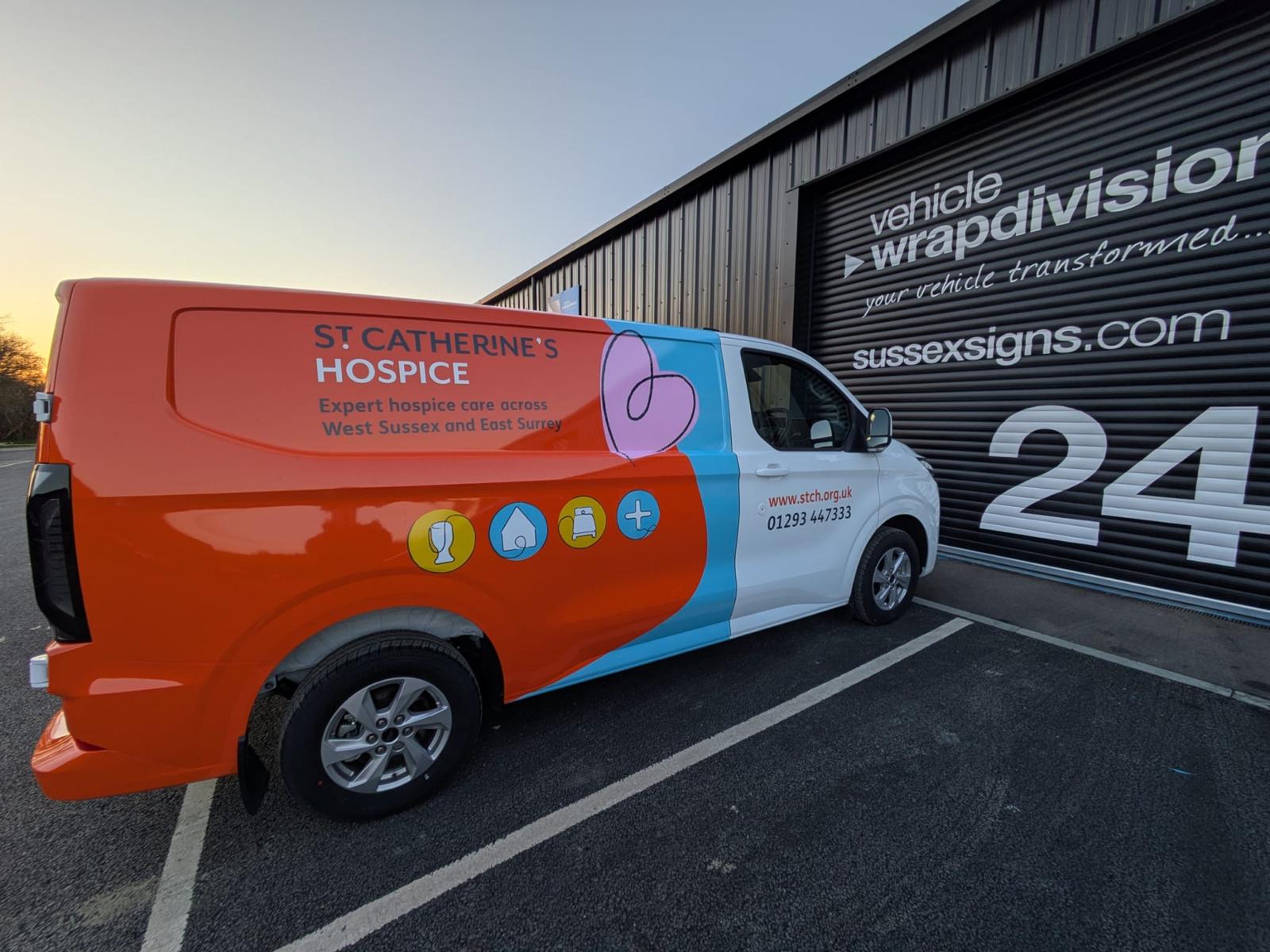 White van transformed with a three-quarter orange and blue printed vinyl wrap for St Catherine's Hospice, providing expert hospice care across West Sussex and East Surrey