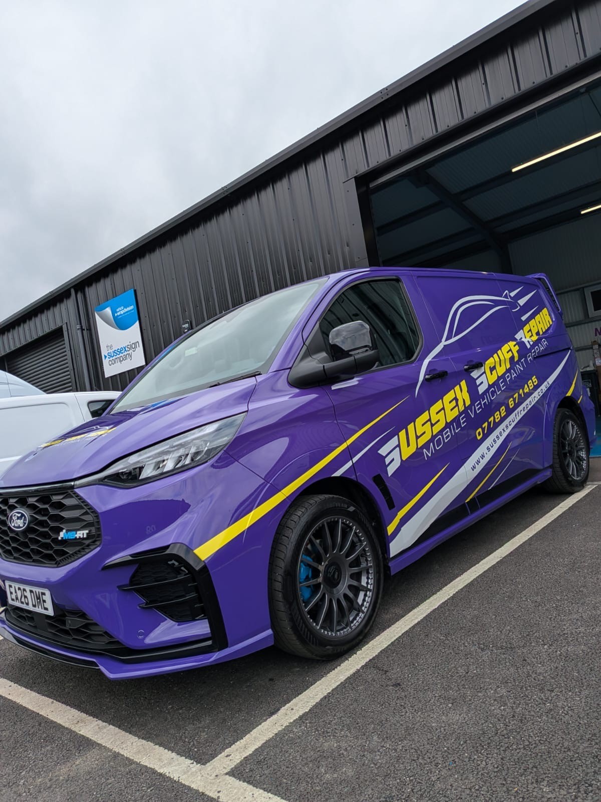 Flat Cut Vinyl Signwriting showcasing the services of Sussex Scuff Repairs from Lewes in East Sussex, the yellow & grey vinyls really standing out on this purple van